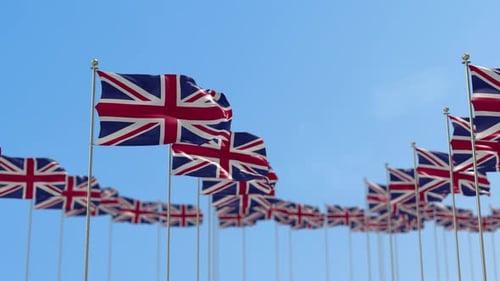 Union Jack Flags Waving Against a Clear Blue Sky