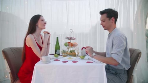 Man Proposes to Woman During Romantic Dinner