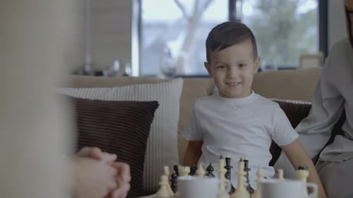Boy Playing Chess With Mother in Home