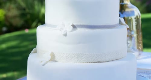 Elegant Wedding Cake with Floral Decorations in Garden