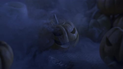 Fog Rolls Around Carved Halloween Pumpkins