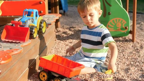 Fair-Haired Boy Playing at the Playground