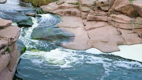 A Small Shining Stream Flows Among Smooth Wet and Dark Stones