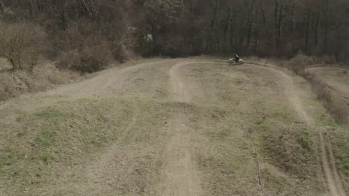 Motorcycle Rider Navigates Dirt Track from Above