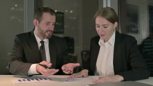 Business Meeting at Night with Serious Discussion
