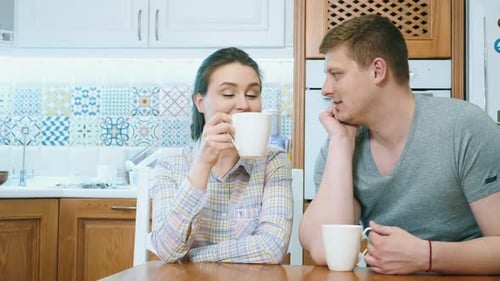 Loving Couple Drinking Coffee in a Bright Kitchen