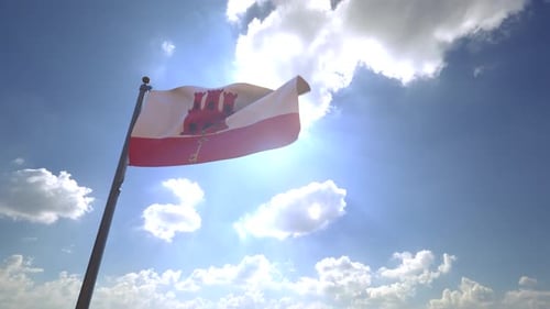 Waving Gibraltar Flag Against Bright Blue Sky