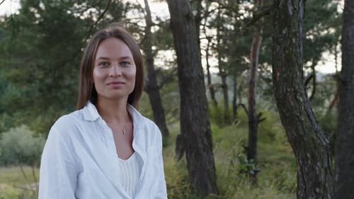 Woman Posing in Forest with Soft Lighting