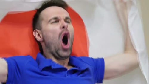 Man Holding Up Flag and Cheering