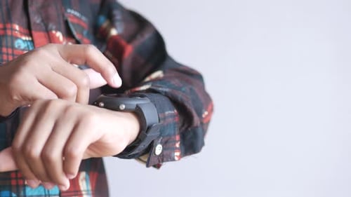 Person Using Smart Watch with Index Finger Indoors