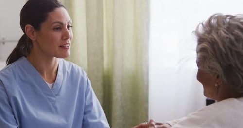 Nurse helping a senior woman in a retirement home