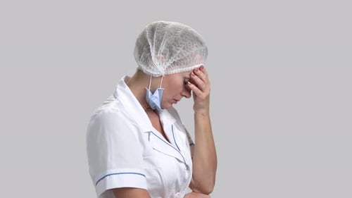 Worried Healthcare Worker with Headache and Stress