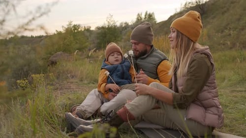 Family of Three with Roasted Marshmallows Outdoors
