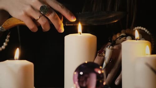Mystical Ritual with Candles, Crystal Ball, and Knife