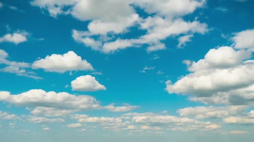 White Clouds Slowly Move Across a Blue Sky