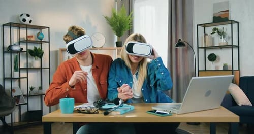 Couple Having Fun With VR Headsets at Home