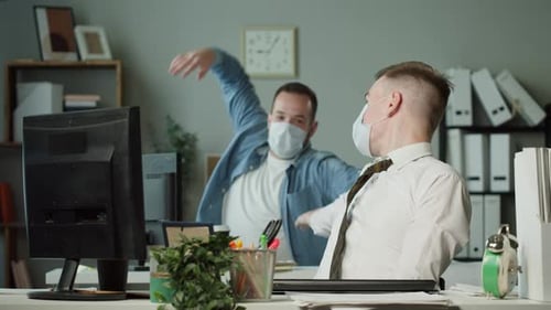 Businessmen Working in Office Two Men Wearing Medical Protective Masks Tossing Papers Up with Joy