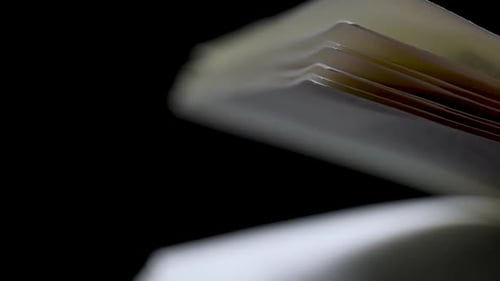 Scrolling Through Blurry Book Pages in Slow Motion