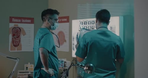 Doctors Studying X-Ray in Medical Office