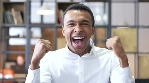 Man Cheering with Excitement in an Office