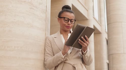 Businesswoman Using Digital Tablet in City Downtown