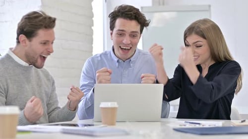 Successful Creative Team Doing High-Five in Modern Office