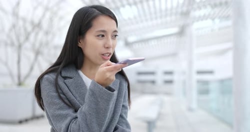 Woman Using Smartphone in City Location