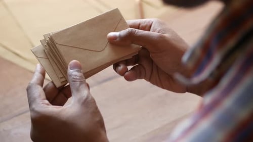 Rear View of Man Hand Holding Many Envelope