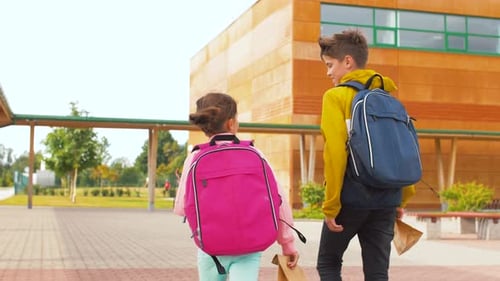 Children with Backpacks Going To School