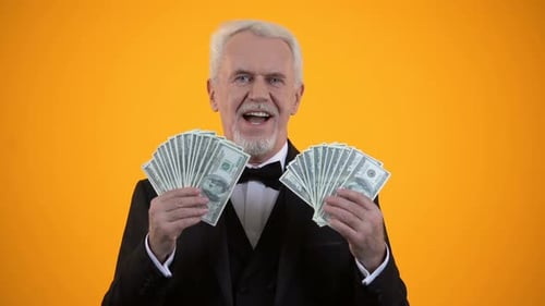 Smiling Man Holds Fans of Money
