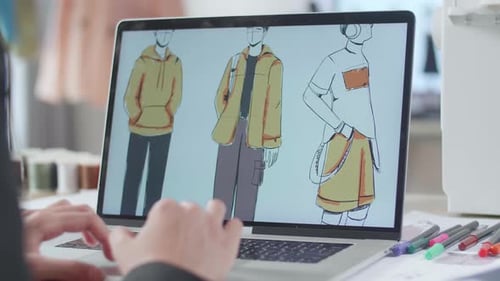 Close Up Of Female Designer'S Hands Designing Clothes On A Laptop In The Studio