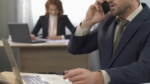 Office Worker Talking on Smartphone with Client at Workplace, Conversation