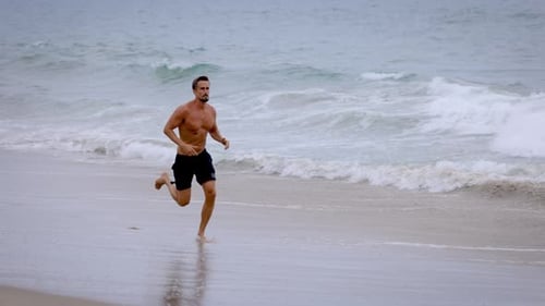Athletic Man Exercising At The Beach