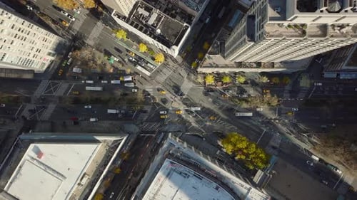 Aerial Birds Eye Overhead Top Down View of Cars Passing Through Intersection