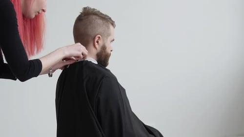 Stylist Trims Man's Hair with Electric Razor