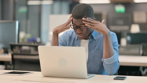 Young Adult Frustrated While Working on Laptop