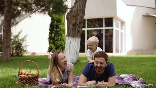 Cheerful Family Picnic on a Green Lawn