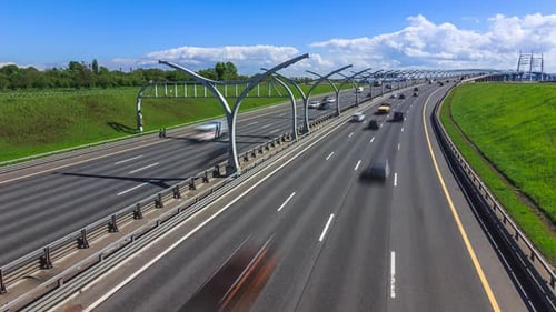 car traffic on the city freeway on a sunny day in city