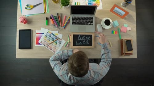 Top View of Man Writing New Idea on Blackboard, Inspired for Startup Business