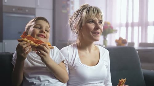 Mother and Child Enjoy Pizza Together at Home