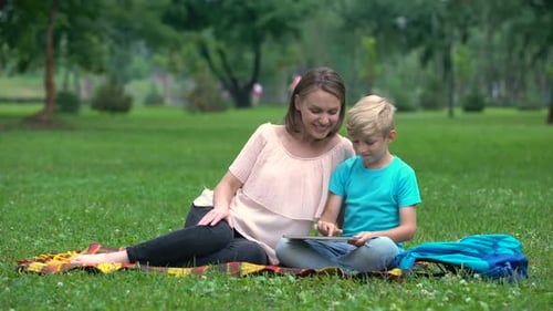 Woman and Child Using Tablet in Grassy Park
