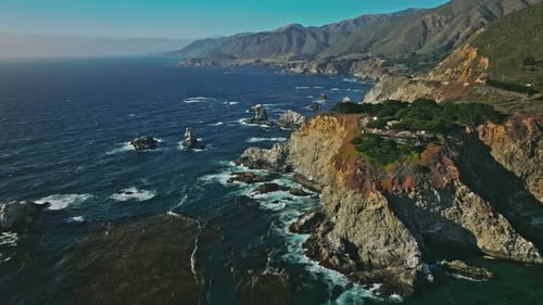 Aerial top view of ocean blue waves break on a coastline