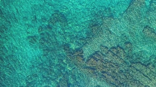 Transparent sea water near stony remote coast