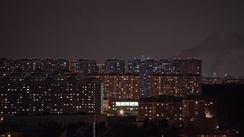 Timelapse of Window Lights and Smoking Pipes in City at Night. Moscow, Russia