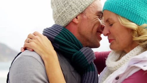Affectionate Couple Embracing on the Beach in Winter