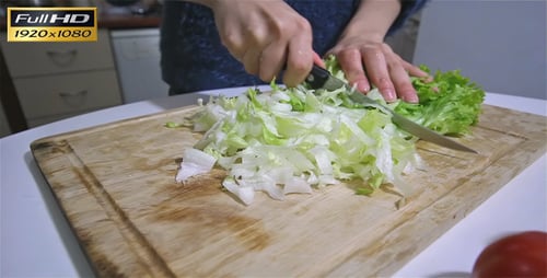 Lettuce Being Cut On A Cutting Board
