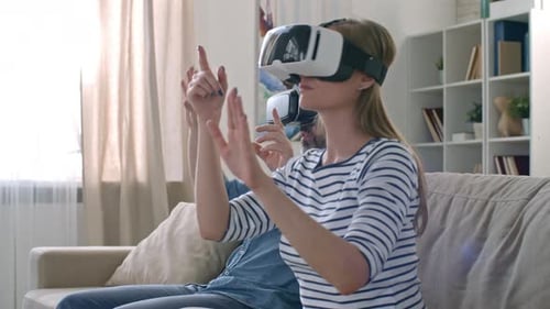 Couple Enjoys a Virtual Reality Experience at Home