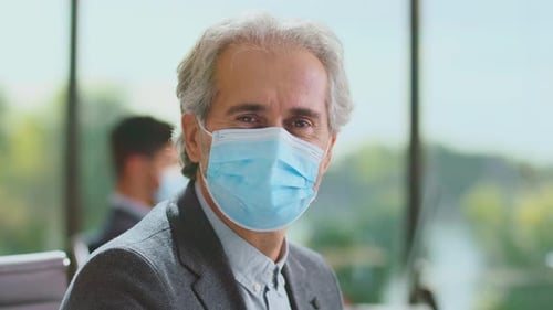 Masked Professional in Modern Bright Corporate Office