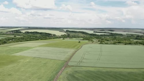 Epic countryside landscape with fields and meadow against blue sky