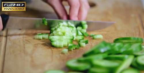 Dicing Fresh Cucumber on Wooden Cutting Board